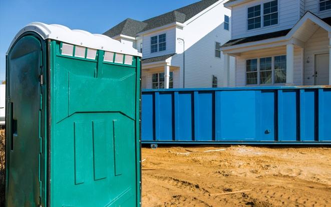 dumpster and portable toilet at a construction site in Boca Raton FL